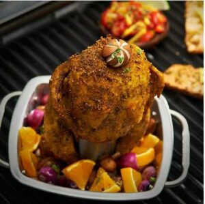 Broil King Chicken Roaster with Pan cooking chicken in BBQ
