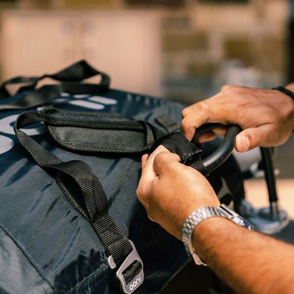 Ooni-Koda-12-Carry-Cover-Man-adjusting-straps.jpeg Ooni-Koda-12-Carry-Cover-Man-adjusting-straps.jpeg